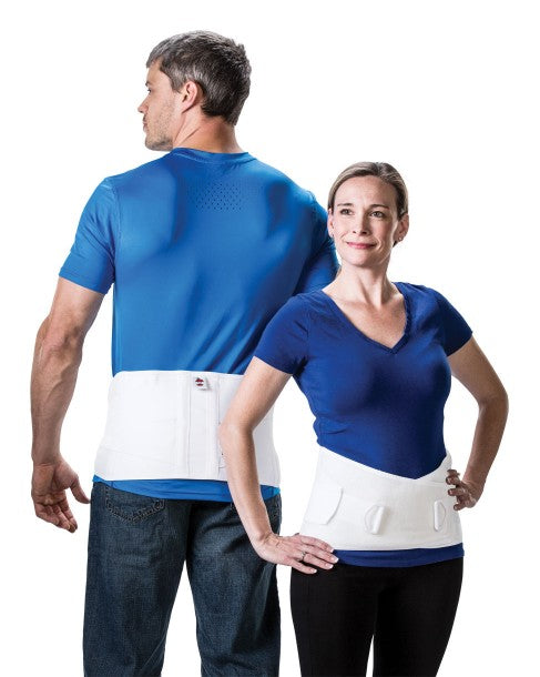 A man and a woman modeling CORFIT LUMBOSACRAL SUPPORT belts, primarily white in color, worn around the lower abdomen and waist area.